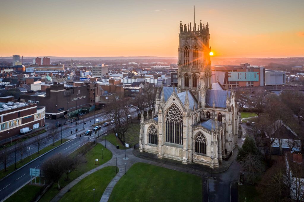 Aerial view of Doncaster Minster, an ancient church, capturing history with a touch of potential car recovery