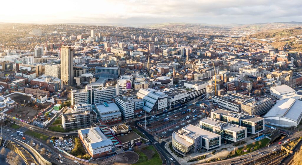 Aerial view of the urban sprawl of Sheffield, offering glimpses of potential car recovery scenarios within the landscape