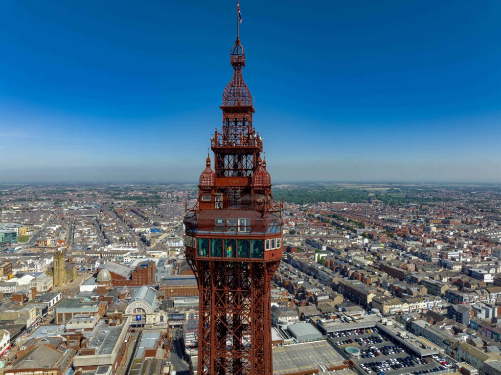 Drone view of Blackpool Tower, combining iconic cityscape with potential car recovery scenes below