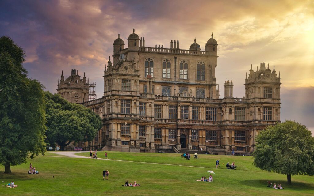 Wollaton Hall, Nottingham, UK, a historic masterpiece, subtly incorporating hints of potential car recovery scenes within the landscape